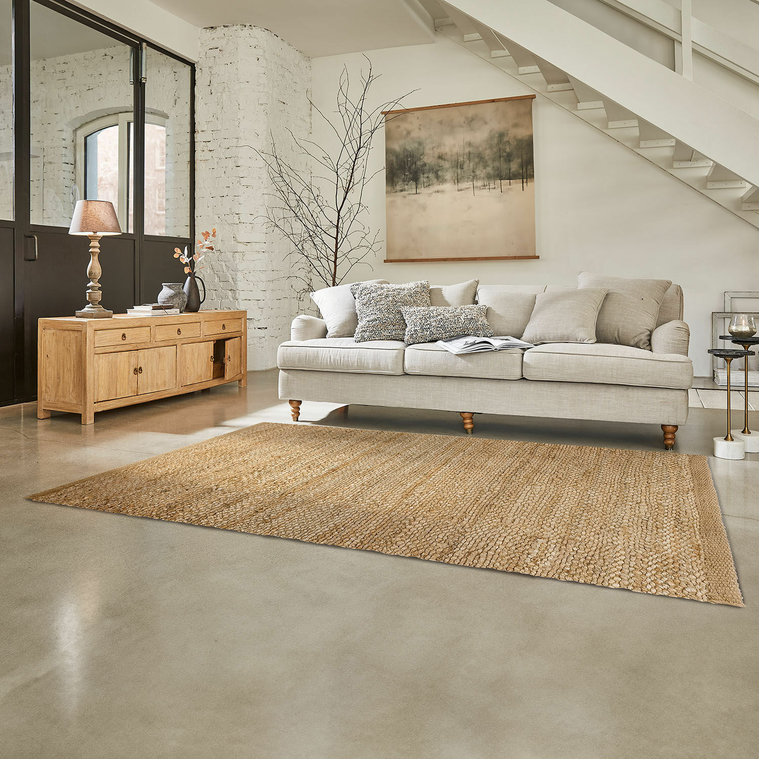 Teppich Abitain Beiges Sofa mit Kissen und natürlichem Jute-Teppich in modernem Wohnzimmer mit Holzkommode