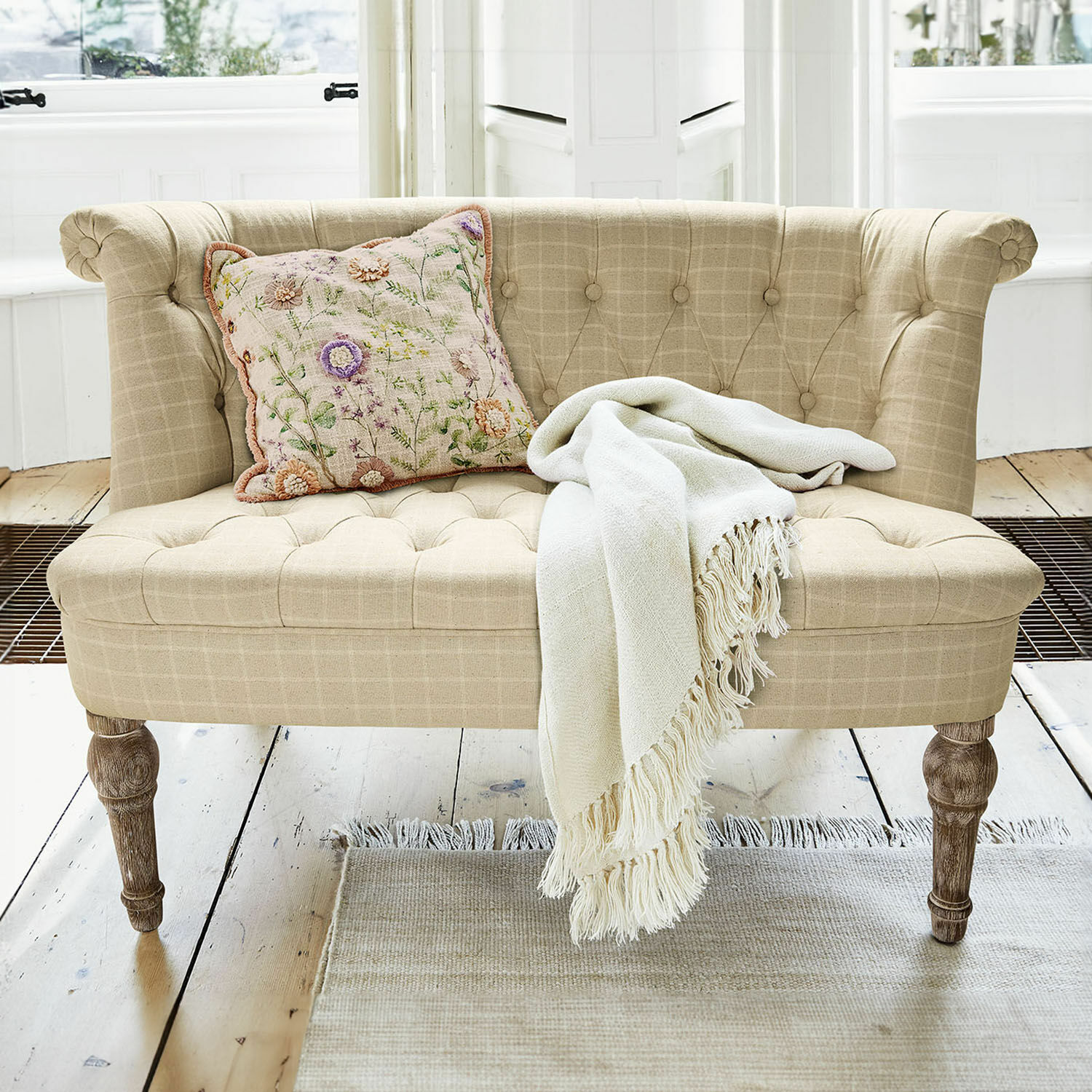 Sofa Weralin Beige gepolstertes Sofa mit Holzbeinen, dekorativem Kissen und cremefarbenem Plaid auf hellem Teppich