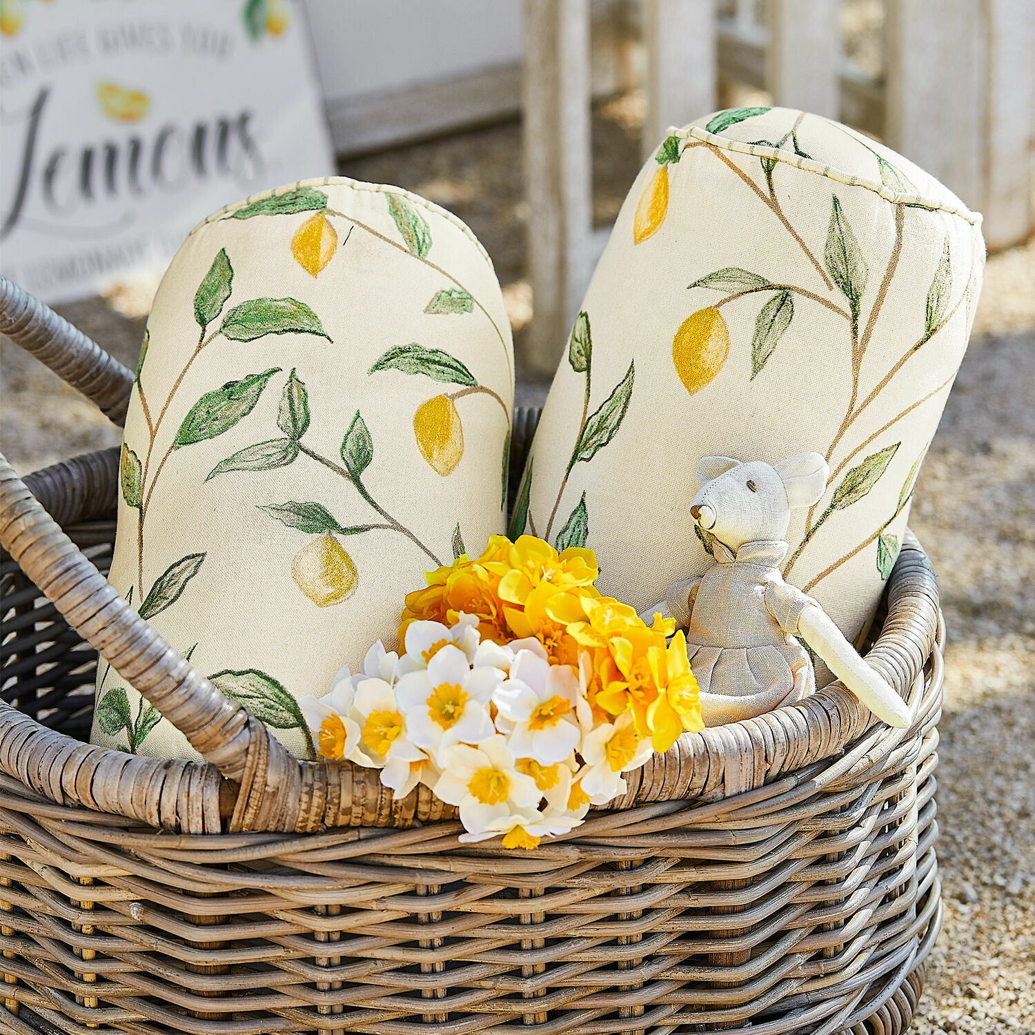Kissenrolle 2er Set Palerina Dekorative Baumwollkissen in Creme mit Zitronenmuster im Korb aus Weide mit gelben und weißen Blumen