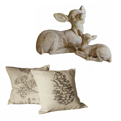 Dekoration mit zwei beigen Kissen mit Zapfen- und Blumenmotiv und einer Steinfigur von zwei Rehen