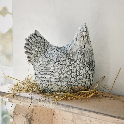Dekorative Hühnerfigur aus grauem Kunststoff auf Stroh, Wohn- und Gartendekoration