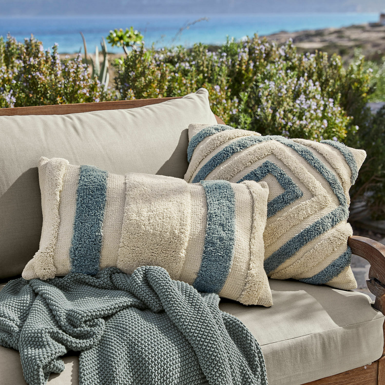 Kissenhülle 2er Set Melyn Beige-blaue dekorative Kissen aus weichem Material auf beigem Sofa mit Strickdecke