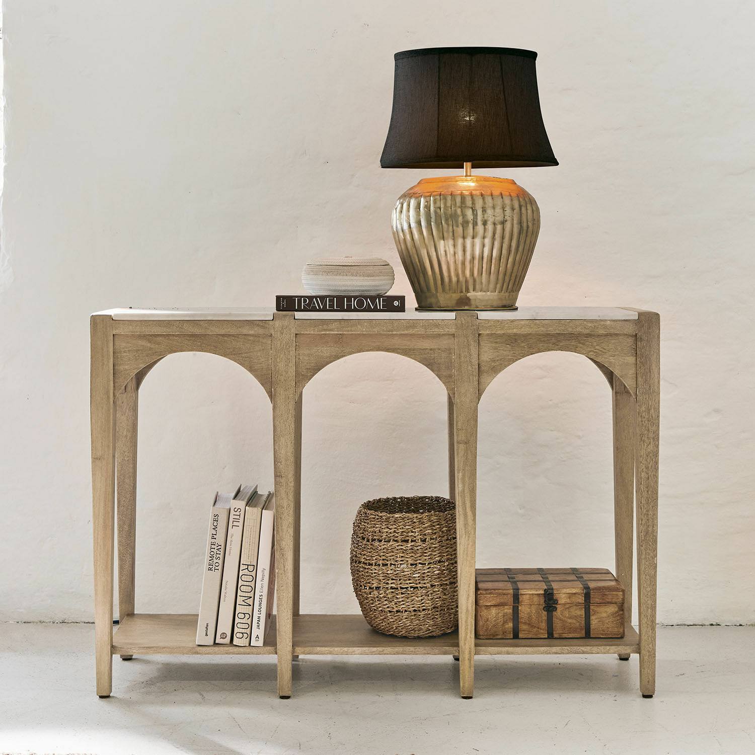 Konsole aus hellem Holz mit Lampe und Dekorationen, stilvolles Möbelstück fürs Wohnzimmer