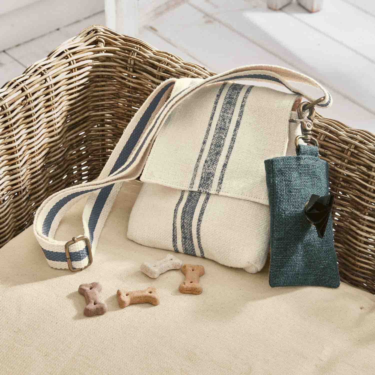 Beige Baumwolltasche mit blauen Streifen und Leckerli-Beutel auf Sofa für Hundezubehör