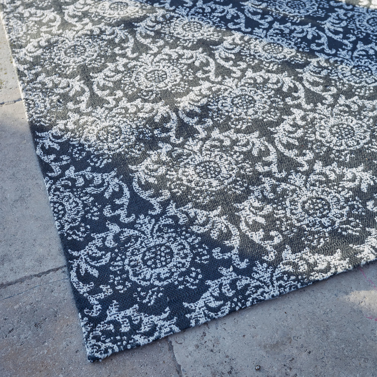 Schwarz-weißer Teppich mit floralem Muster aus robustem Material, ideal für Wohnzimmer und Dekor