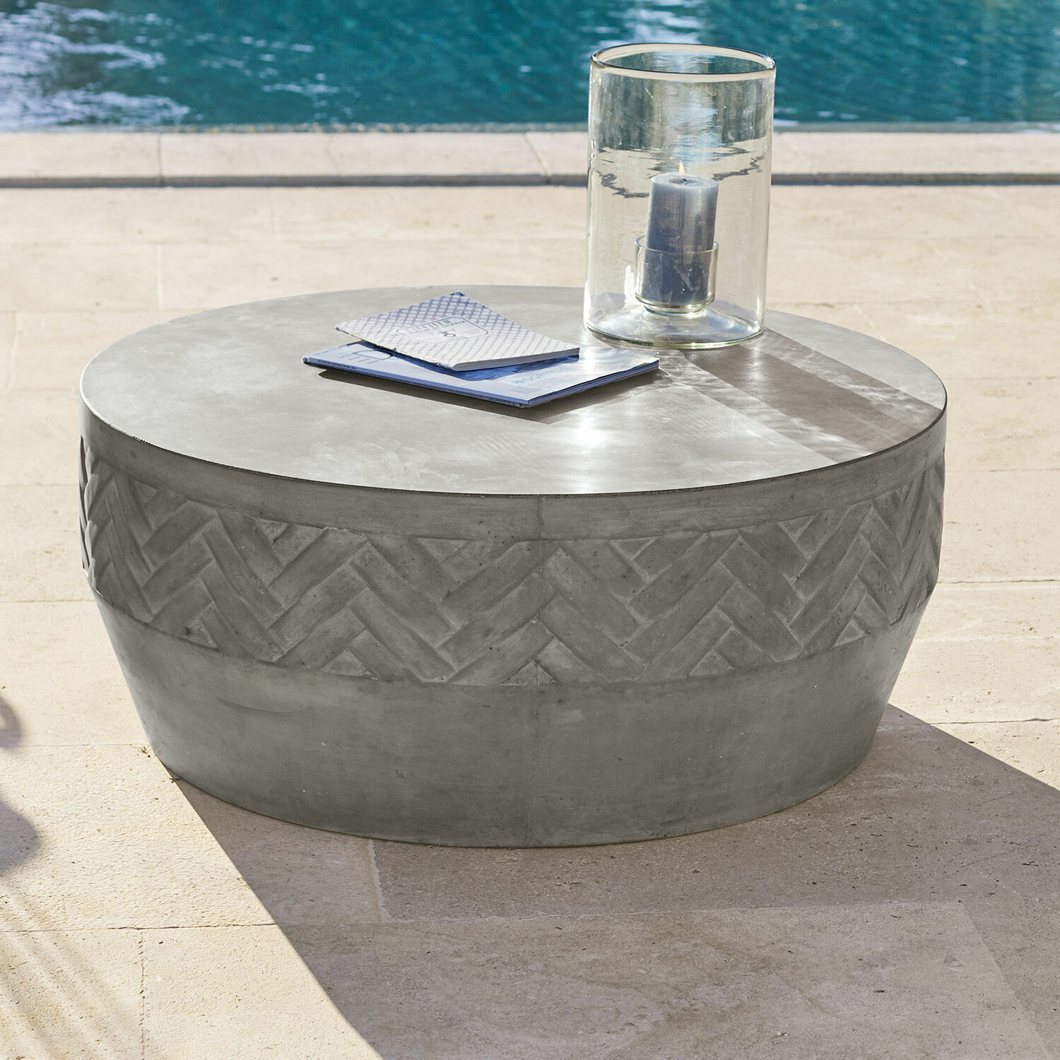 Runder Couchtisch aus grauem Beton mit geometrischem Muster, ideal für Terrasse
