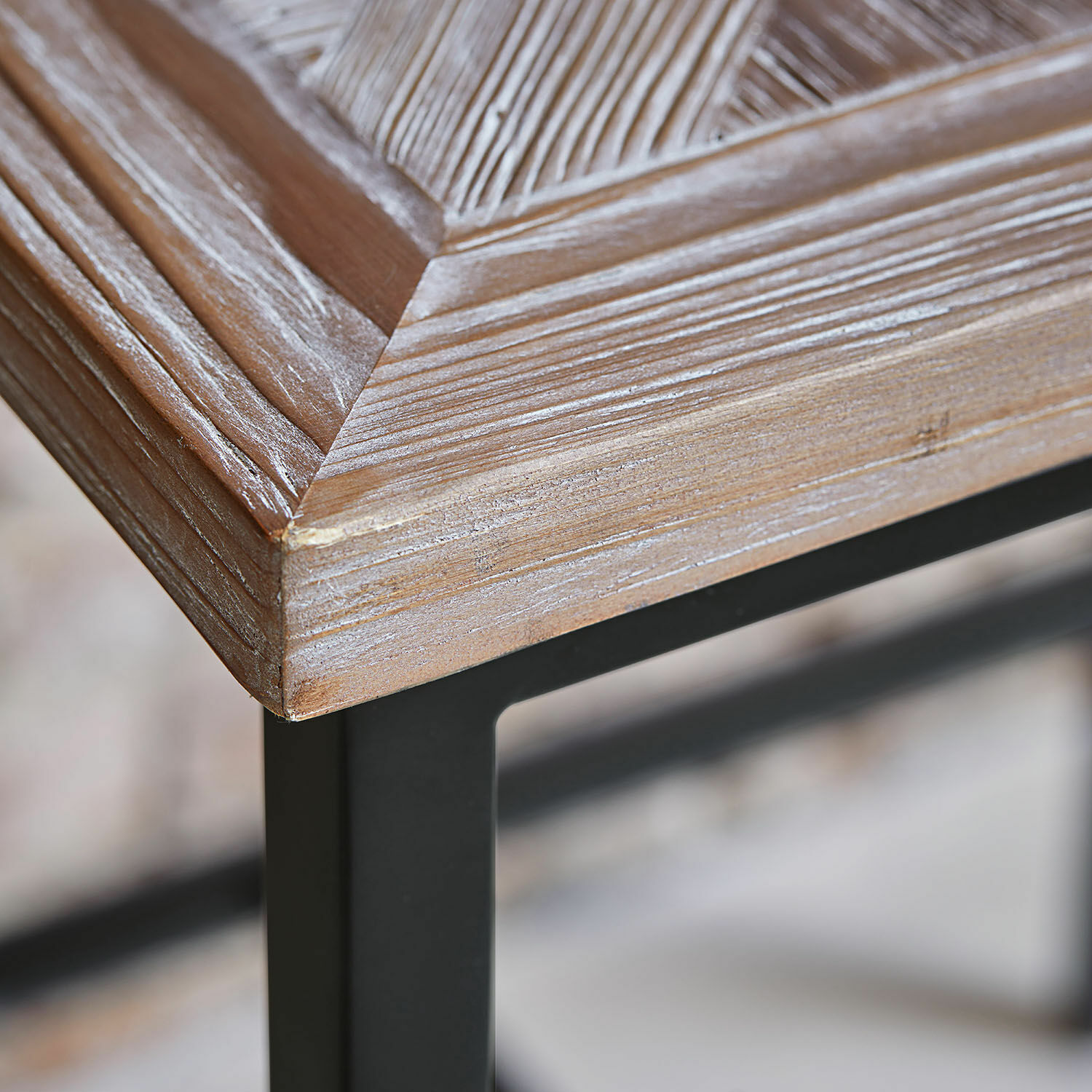 Eckdetail eines Holztisches mit schwarzem Metallgestell, natürliche Holzmaserung sichtbar