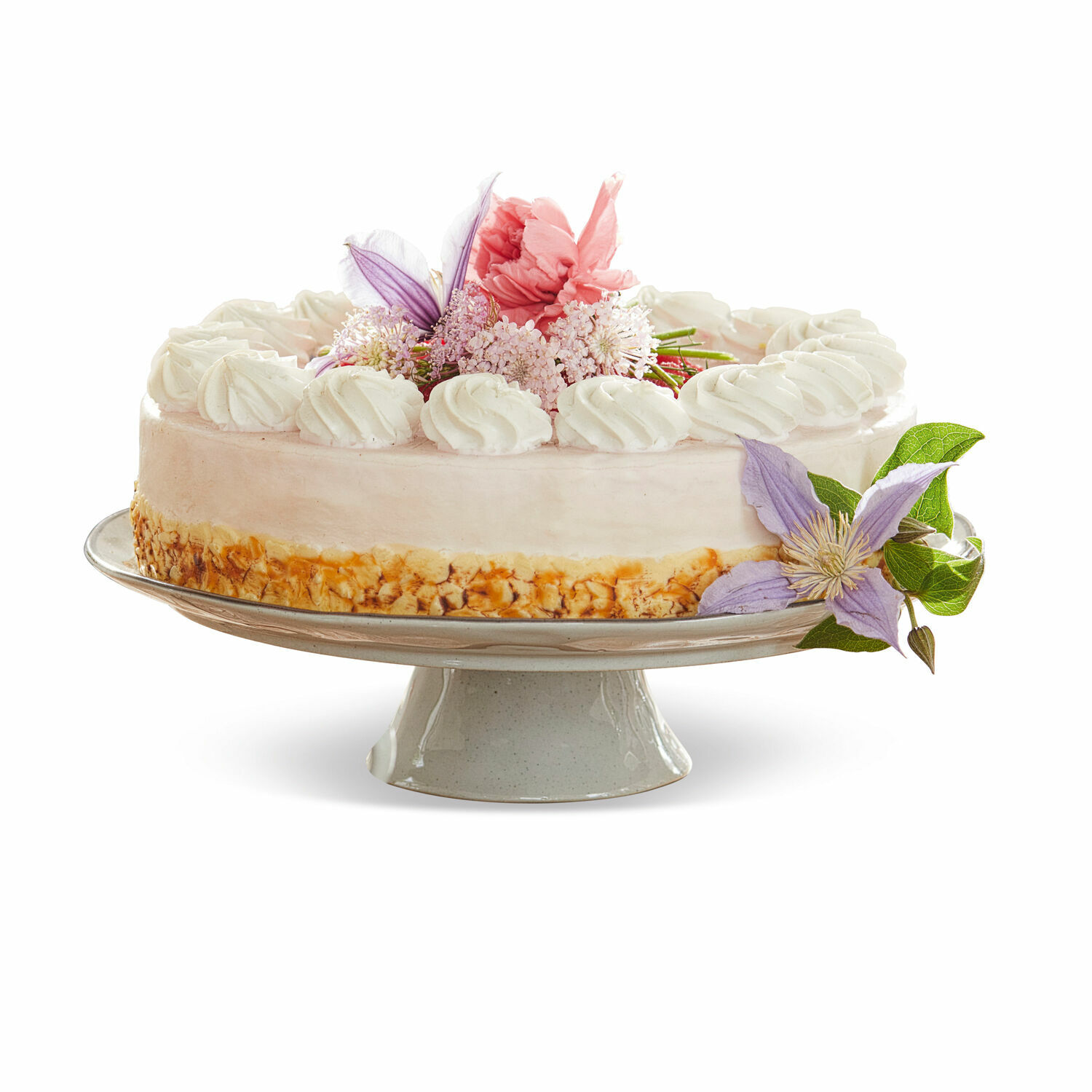 Platte Biarré Torte auf Keramikständer mit Creme und pastellfarbener Blumendekoration