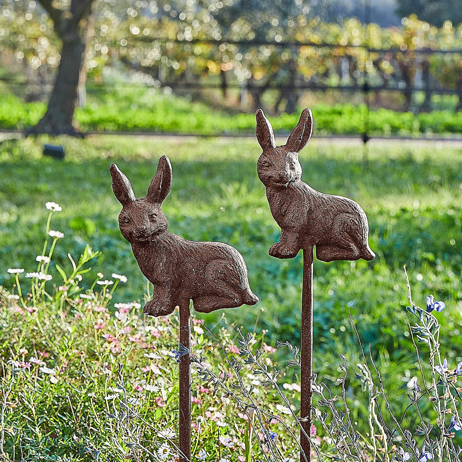 Gartenstab 2er Set Dariyah Dekorative Gartenstäbe mit rostigen Metall-Hasen vor grünem Hintergrund mit Blumen
