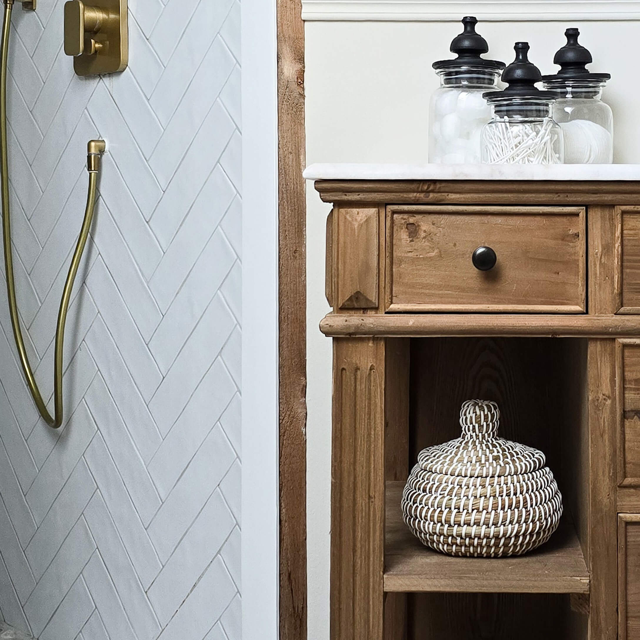 Rustikaler Holz-Badezimmerschrank mit weißer Arbeitsplatte und Glasbehältern für Accessoires