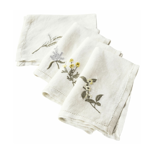Weiße Leinen-Servietten mit floralen Stickereien, dekorativ und elegant für den Tisch