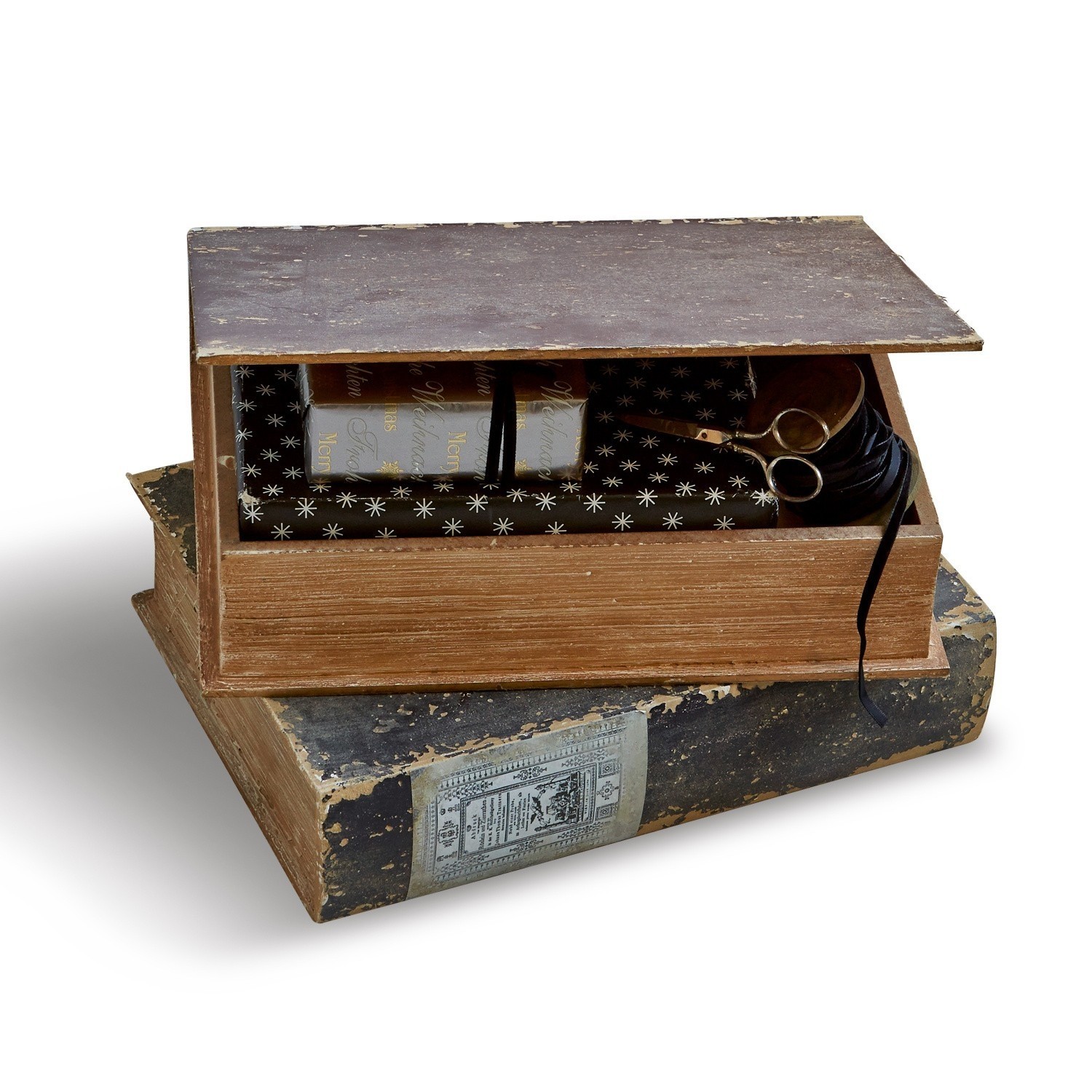 Holzbox in Buchform mit Schere und Geschenkpapier mit Sternenmuster zum Verpacken