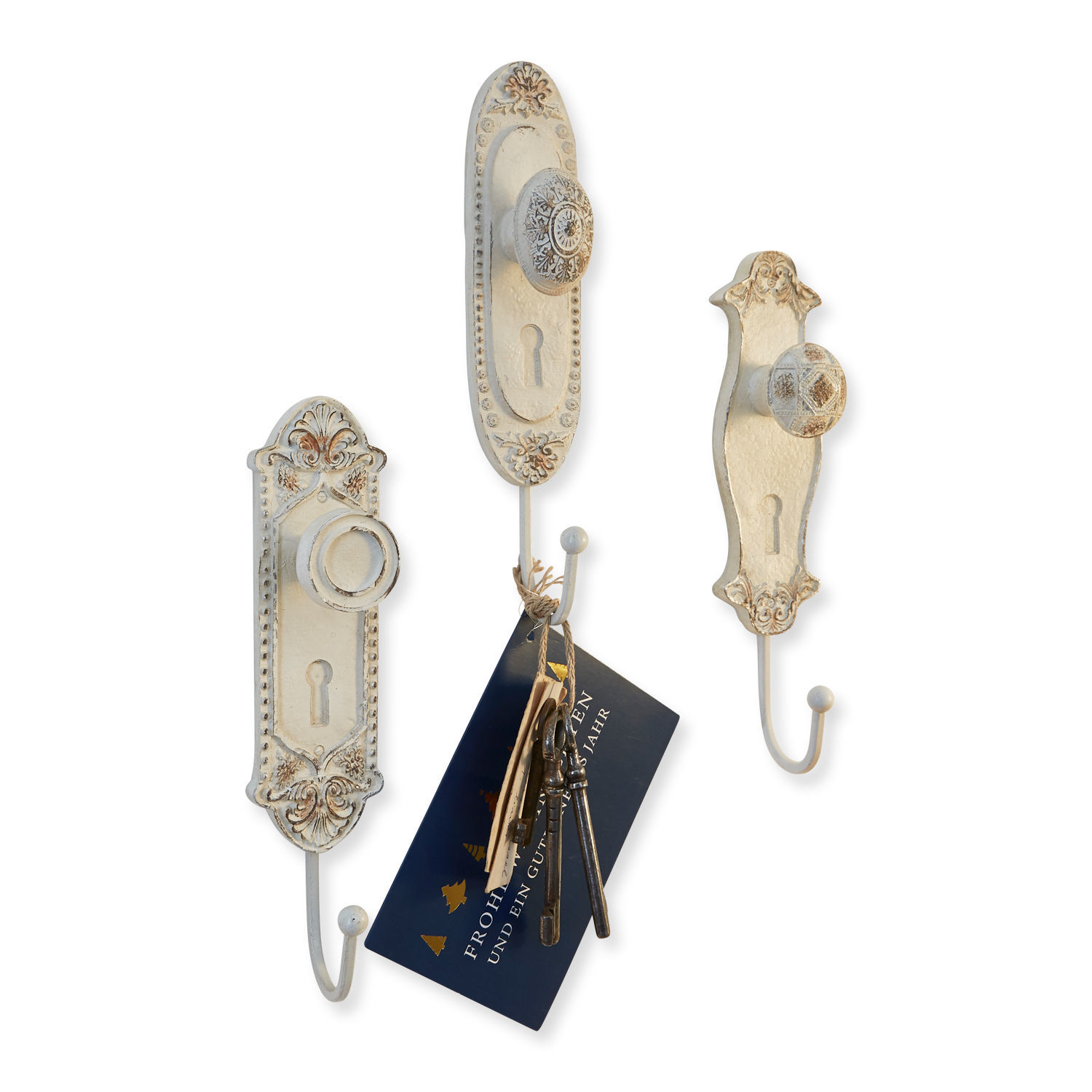 Set aus drei weißen Metall-Wandhaken mit dekorativen Knöpfen und Schlüsselhaken