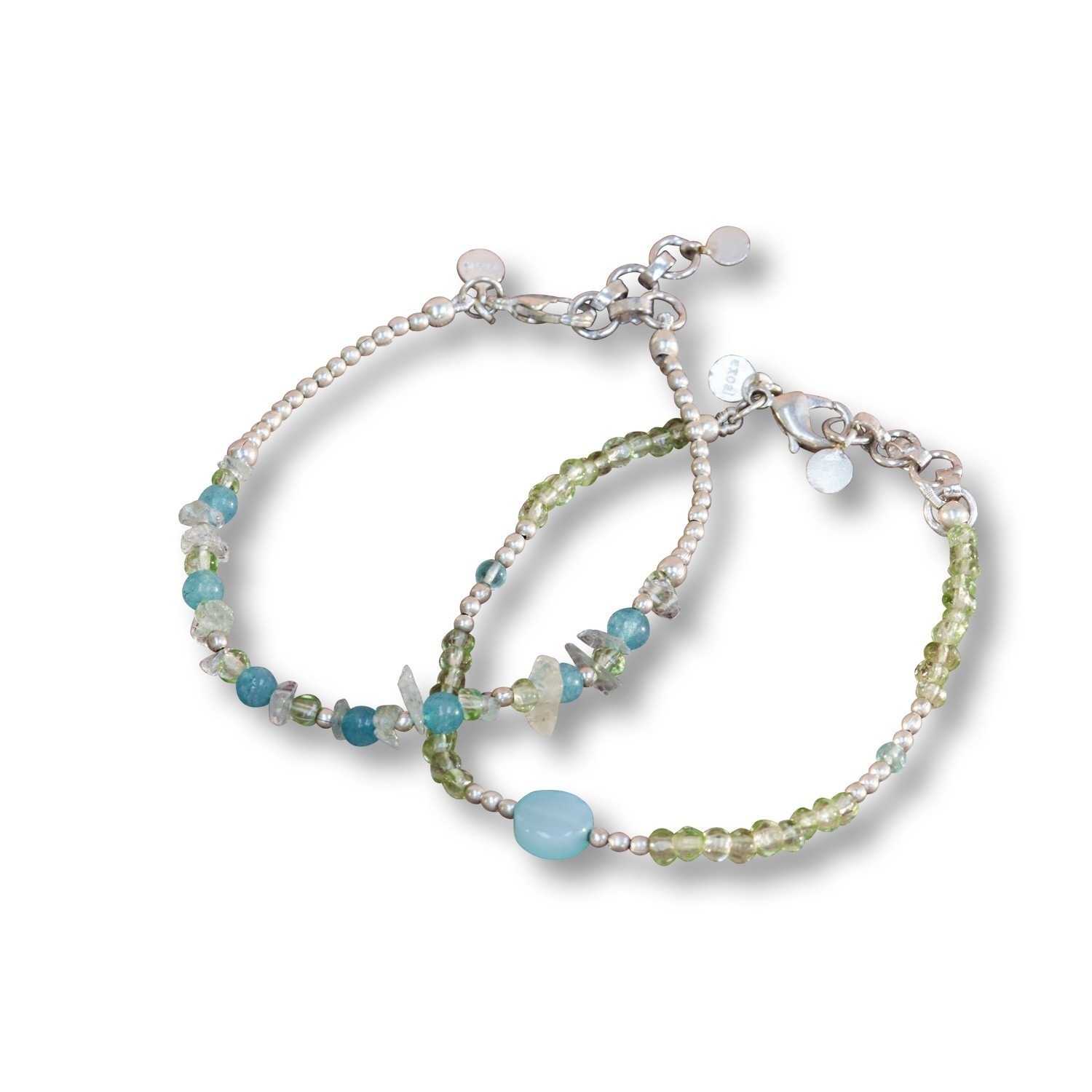 Zarte Armbänder aus Perlen und grünen sowie blauen Steinen, elegante Damenschmuck.