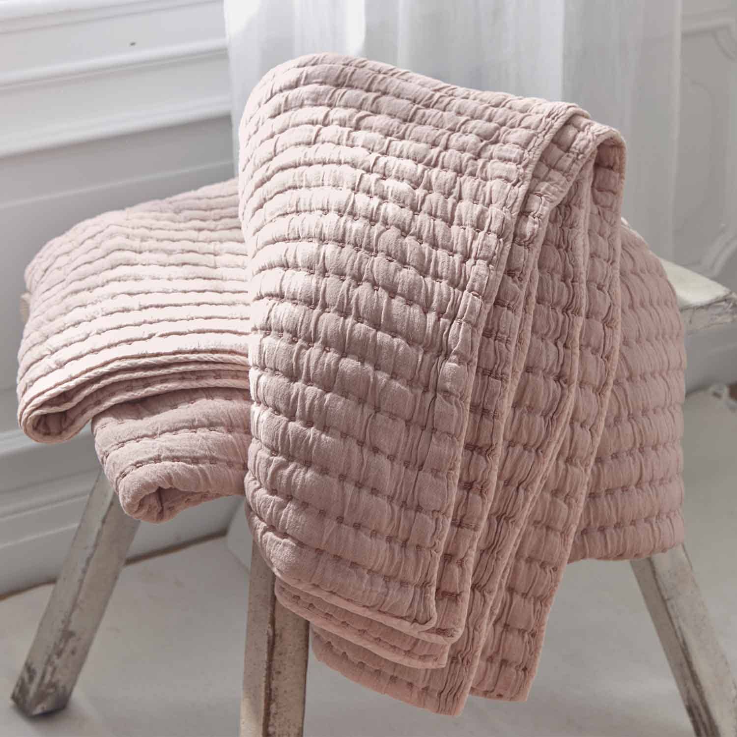 Weiche rosa Baumwolldecke mit wabenartiger Steppstruktur, ideal für gemütliche Wohnräume