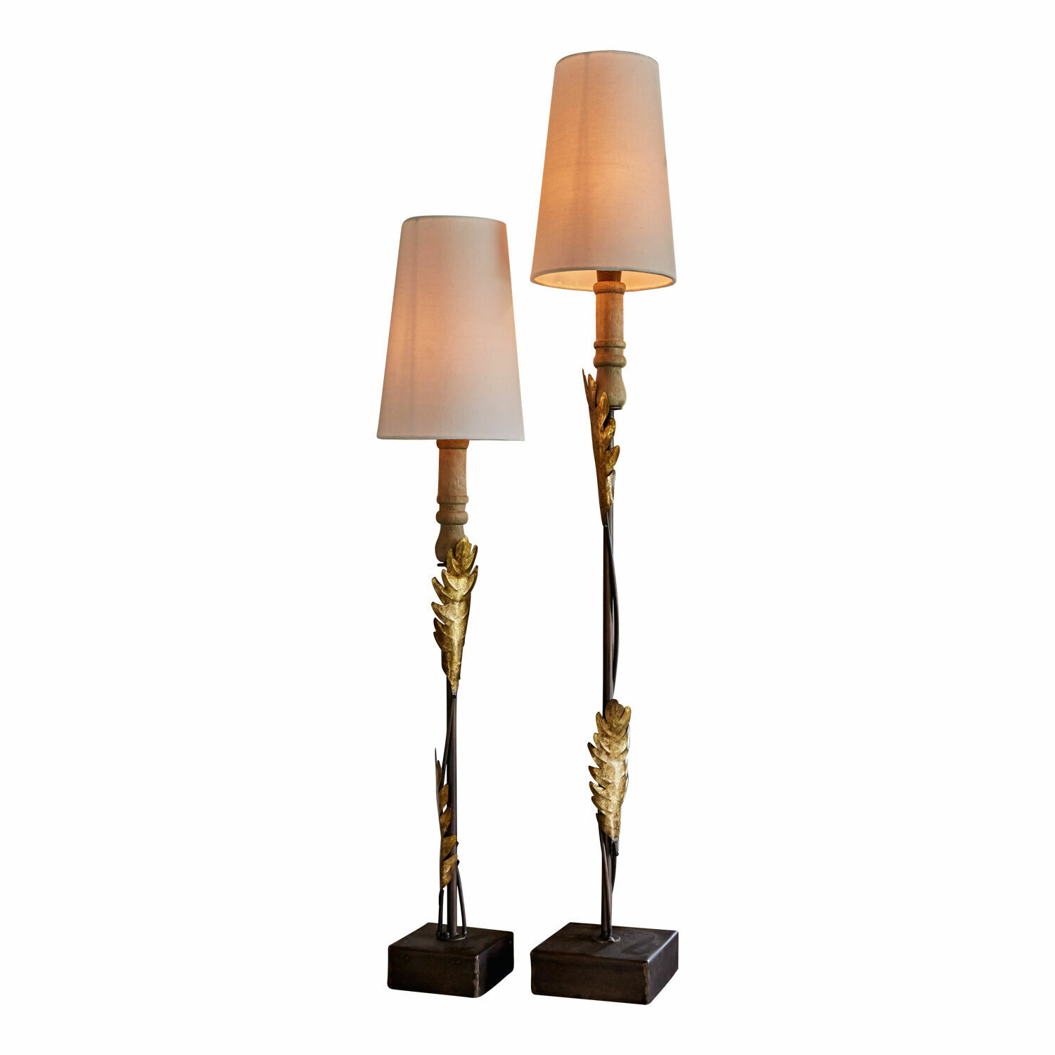 Paar Stehlampen mit goldenen Metallblättern und cremefarbenen Lampenschirmen auf Holzsockeln